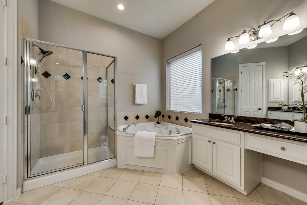    Spa Like Master Bathroom with Separate Vanities with Granite Countertops and Jetted Corner Tub 