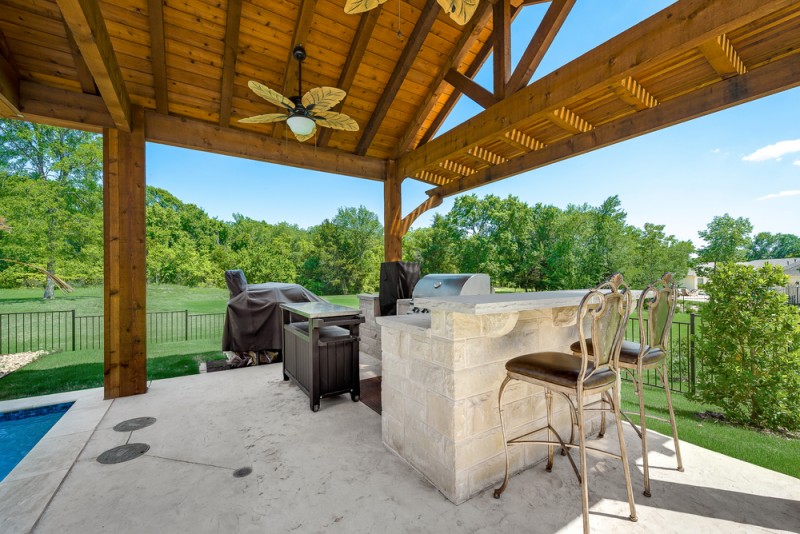    Outdoor Kitchen features Gas Grill and Concrete Bar with Seating 