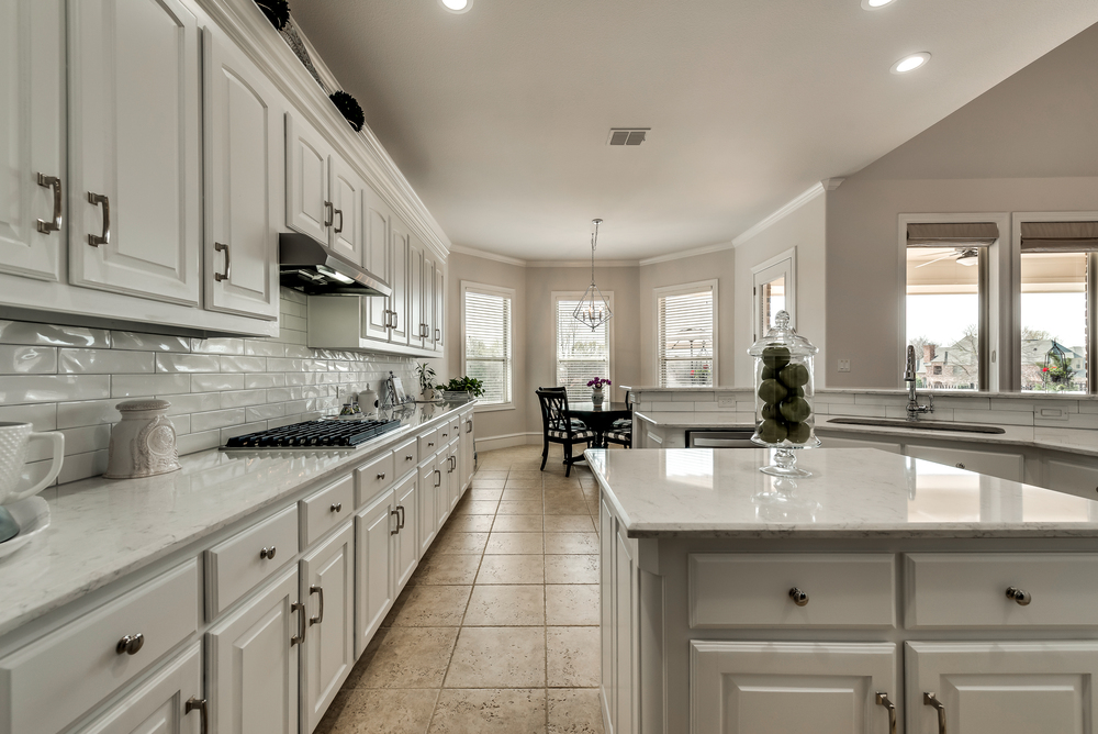    Quartz Countertops Travertine Floors and Stainless Steel Appliances 