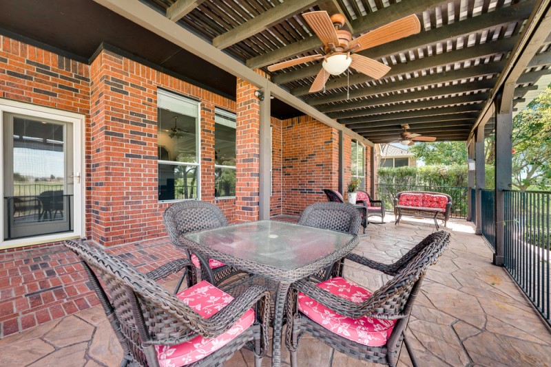    Extended Covered Stamped Concrete Patio with Fans and Shades 