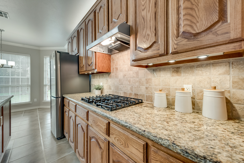    Kitchen with Granite Counters and Tumbled Stone Backsplash 