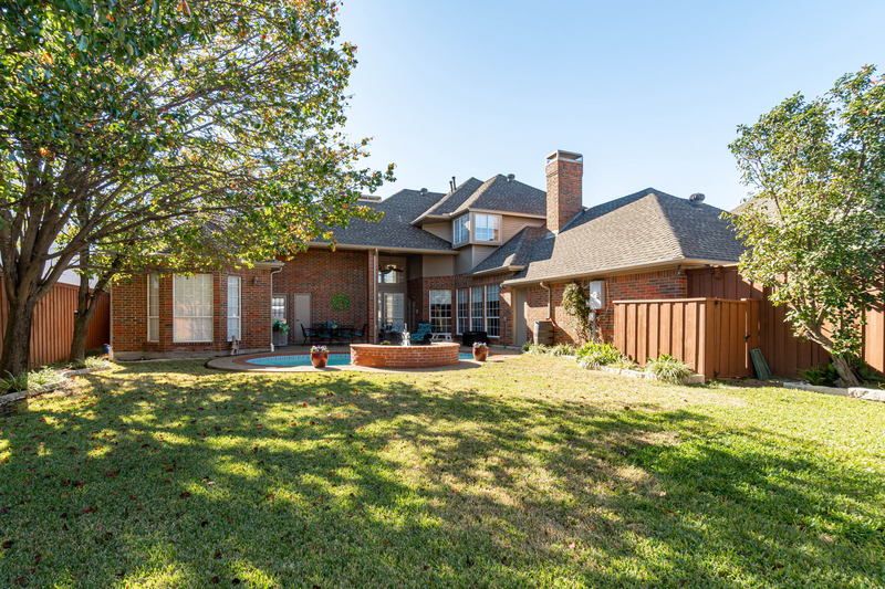    Backyard Grassy Area Surrounded by Board on Board Wood Fence 