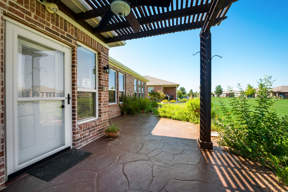   Stamped Concrete Patio Covered with Wooden Arbor 