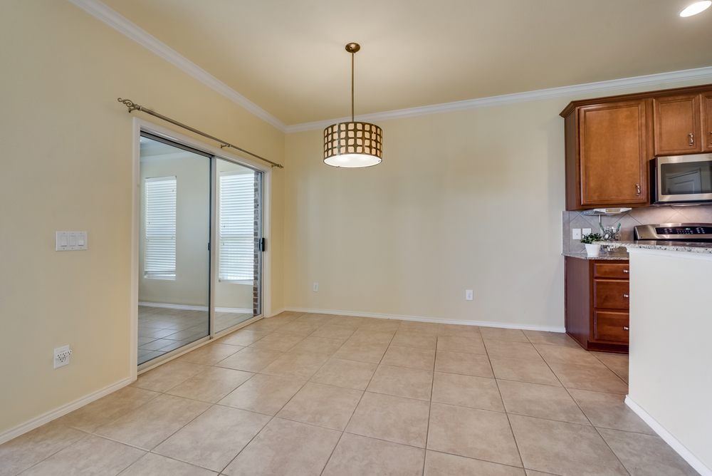    Breakfast Area with Chic Decorative Lighting and Door to Sunroom 