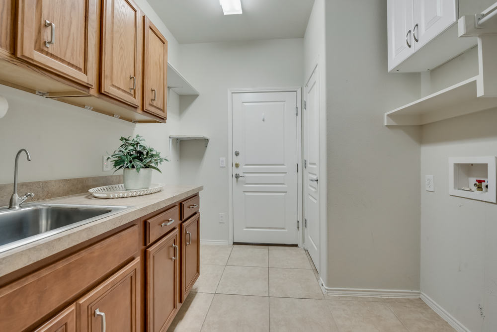    Utility with Built in Cabinetry Sink Walk in Closet and Room for Refrigerator 