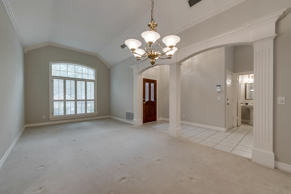    Stacked Formals with Rich Millwork and Plantation Shutters Welcome You 