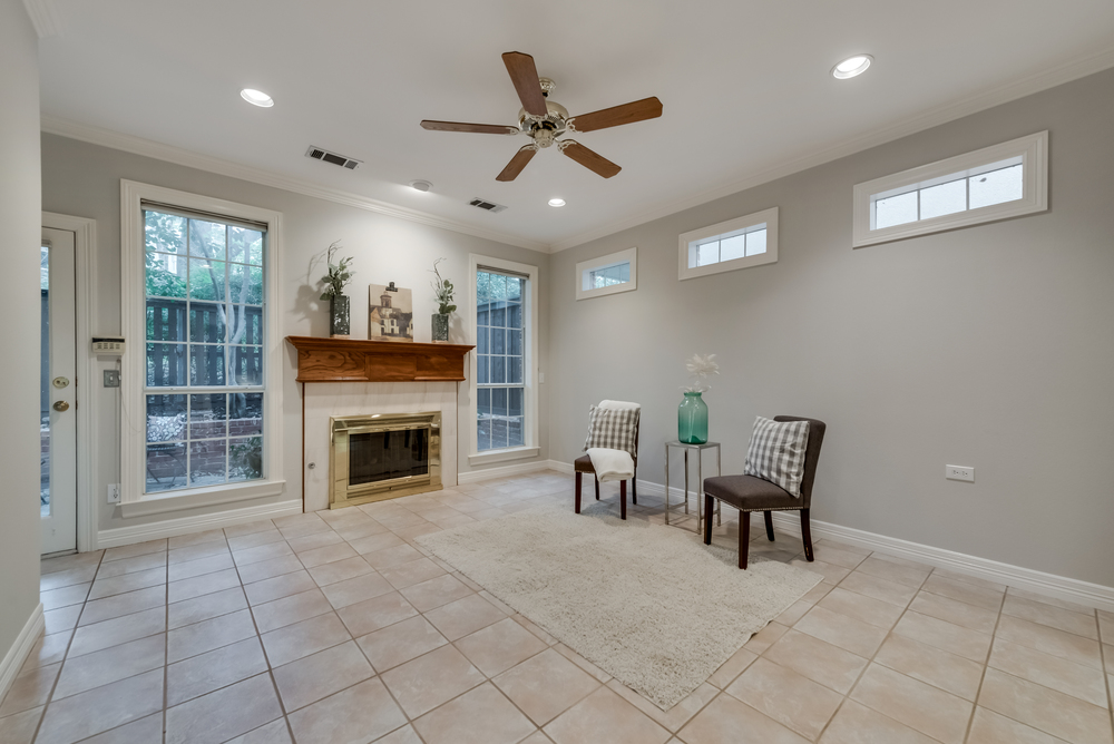    Inviting Family Room offers Tile Floors Gas Log and Wood Burning Fireplace and Door to Back Patio 
