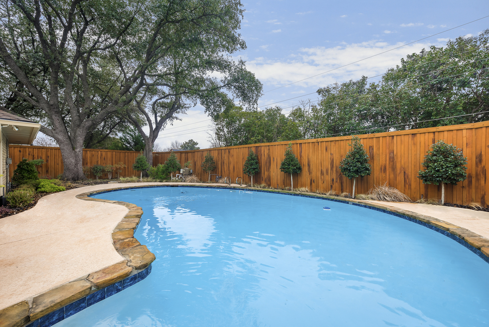    Backyard Oasis with Mature Trees  Sparkling Swimming Pool and Covered and Extended Patio 