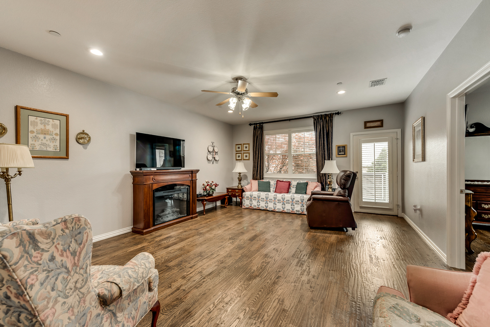    Inviting Family Room Free Standing Electric Fireplace and Plantation Shutters 