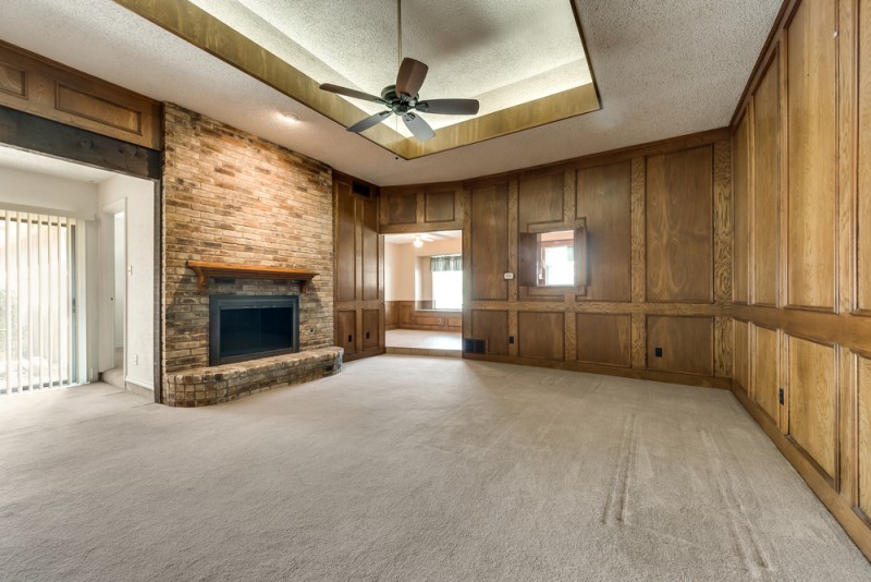    Inviting Family Room with Wood Paneling and Wood Burning Fireplace 
